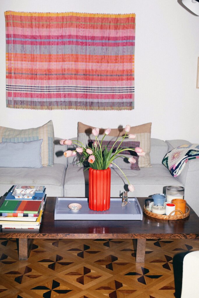 Colourful interior of Anouck Mutsaerts’ home with books, flowers, textiles and collected objects.