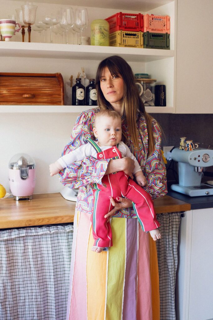 Anouck Mutsaerts holding her baby in the kitchen of her home.