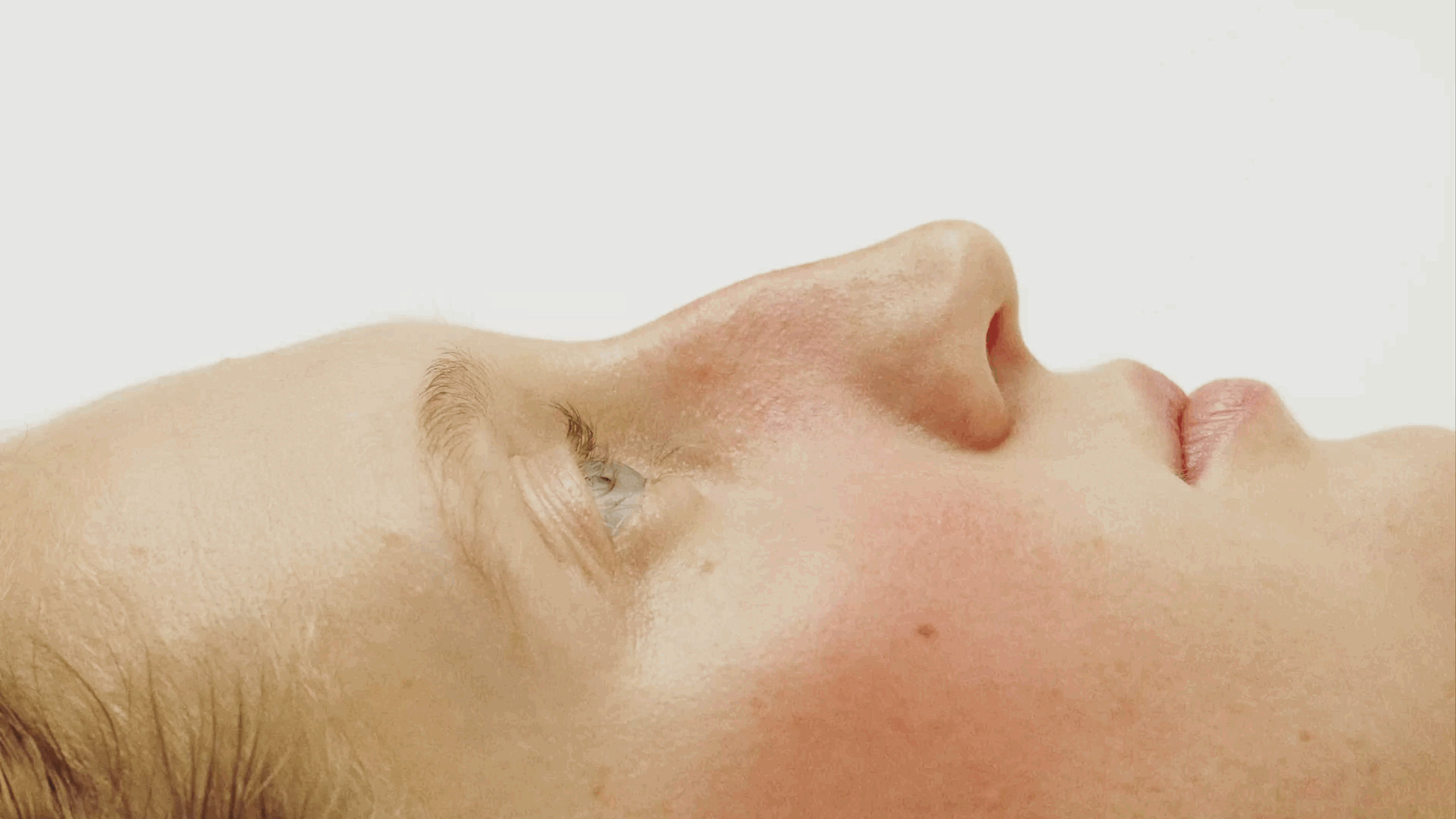 Extreme close-up of Sasha Konograeva’s eye and surrounding natural skin texture.